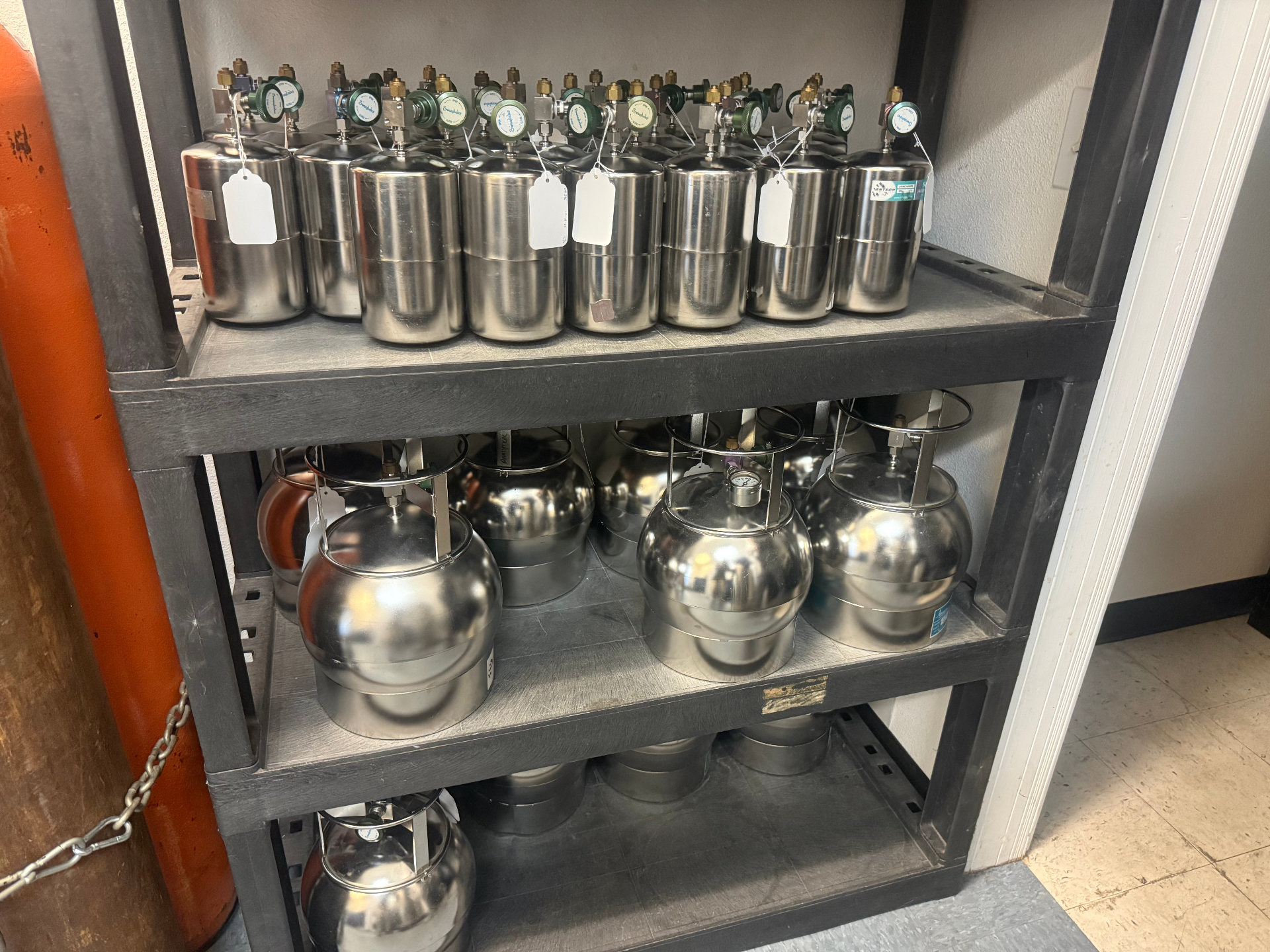 Summa canisters staged on a lab shelf for air quality sampling.